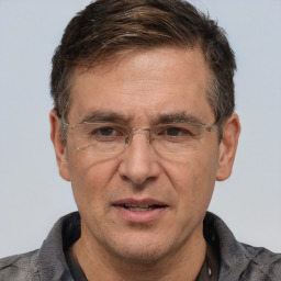 Joyful white middle-aged male with short  brown hair and brown eyes