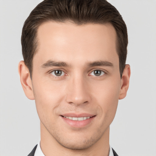 Joyful white young-adult male with short  brown hair and brown eyes