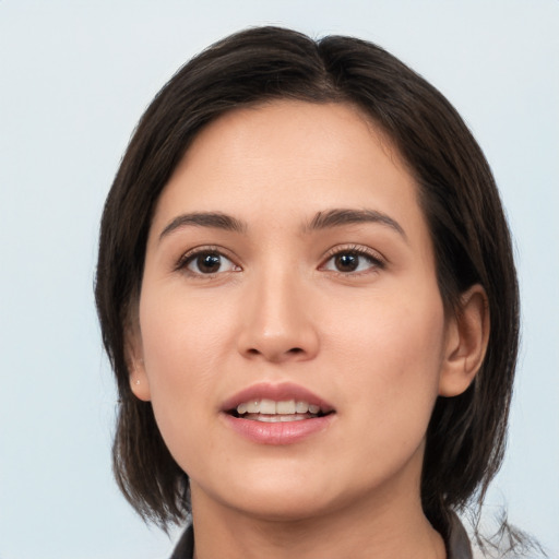 Joyful white young-adult female with medium  brown hair and brown eyes