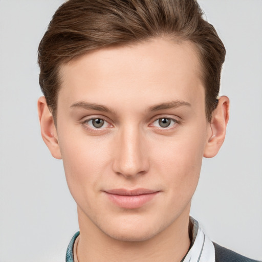 Joyful white young-adult male with short  brown hair and grey eyes