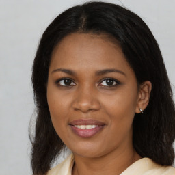 Joyful black young-adult female with medium  brown hair and brown eyes