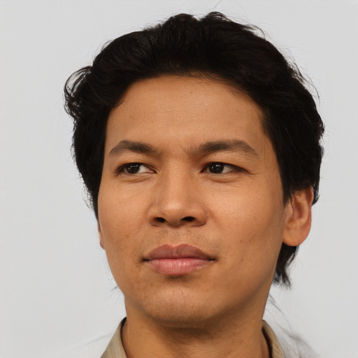 Joyful asian adult male with short  brown hair and brown eyes