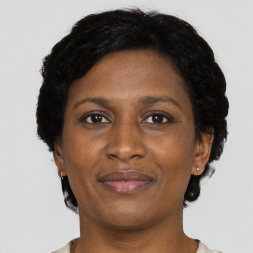 Joyful black adult female with short  black hair and brown eyes