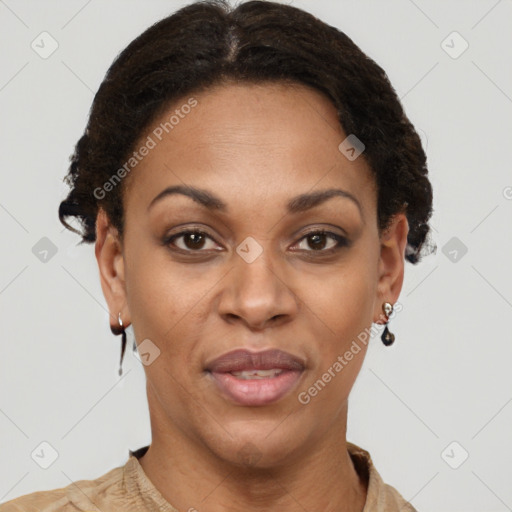 Joyful black adult female with short  brown hair and brown eyes