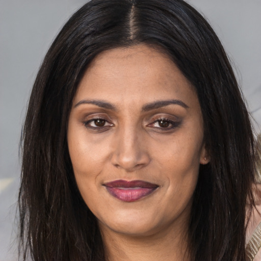 Joyful asian adult female with long  brown hair and brown eyes