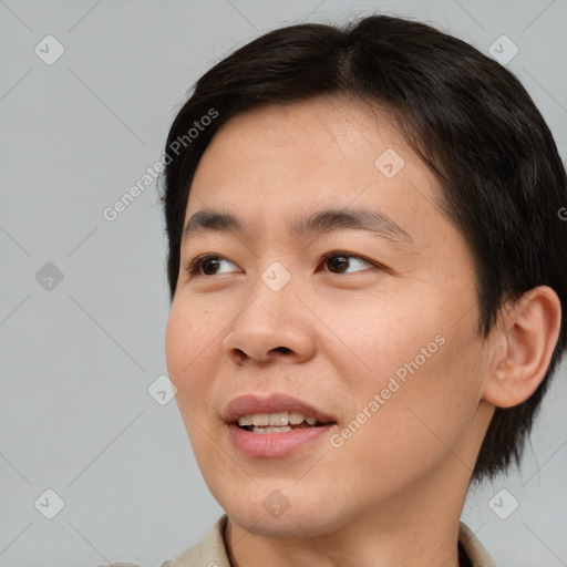Joyful asian young-adult male with short  brown hair and brown eyes