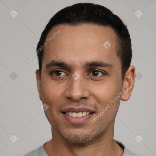 Joyful latino young-adult male with short  black hair and brown eyes