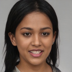 Joyful latino young-adult female with medium  brown hair and brown eyes