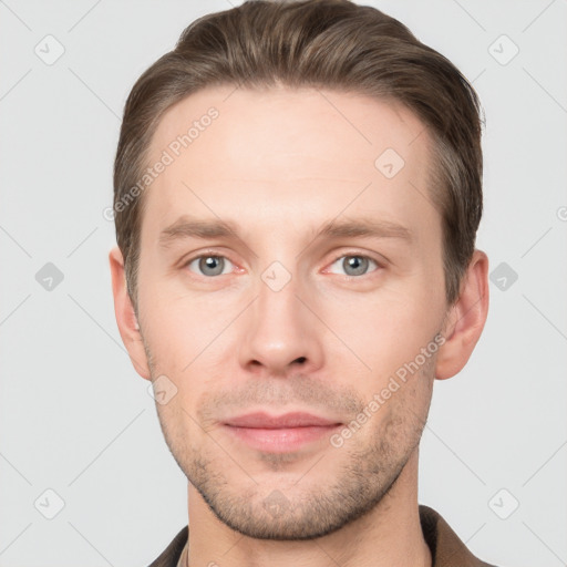 Joyful white young-adult male with short  brown hair and grey eyes