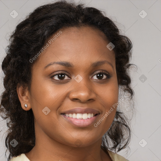 Joyful black young-adult female with long  brown hair and brown eyes