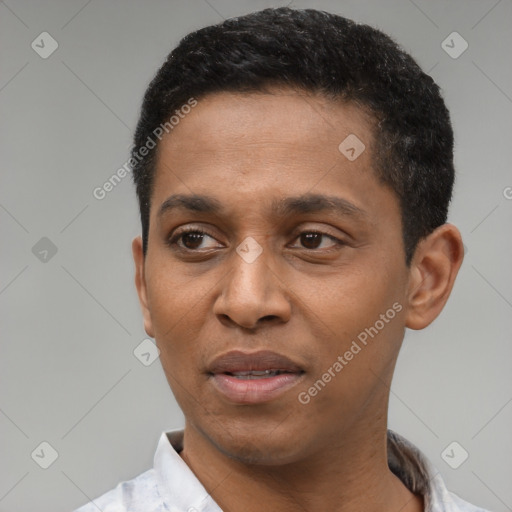 Joyful latino young-adult male with short  black hair and brown eyes