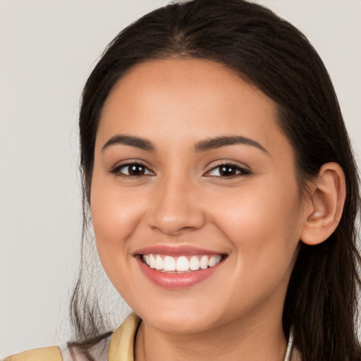 Joyful white young-adult female with long  brown hair and brown eyes