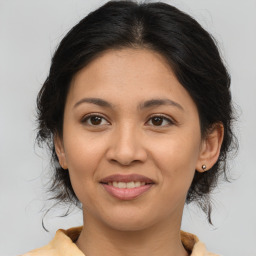 Joyful latino young-adult female with medium  brown hair and brown eyes