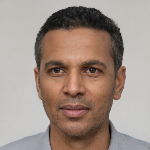 Neutral latino adult male with short  black hair and brown eyes