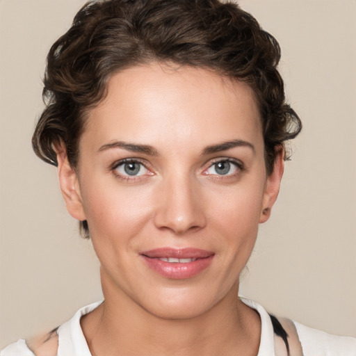 Joyful white young-adult female with short  brown hair and green eyes