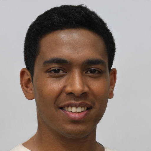 Joyful black young-adult male with short  black hair and brown eyes