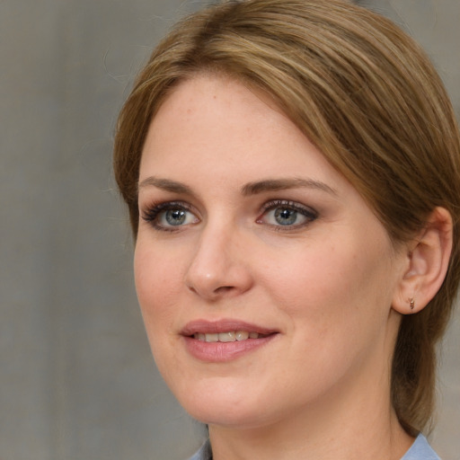 Joyful white young-adult female with medium  brown hair and blue eyes