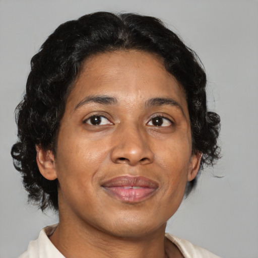 Joyful black adult female with medium  brown hair and brown eyes