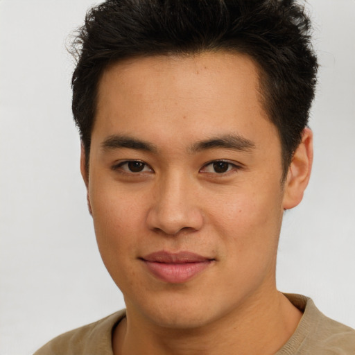 Joyful asian young-adult male with short  brown hair and brown eyes