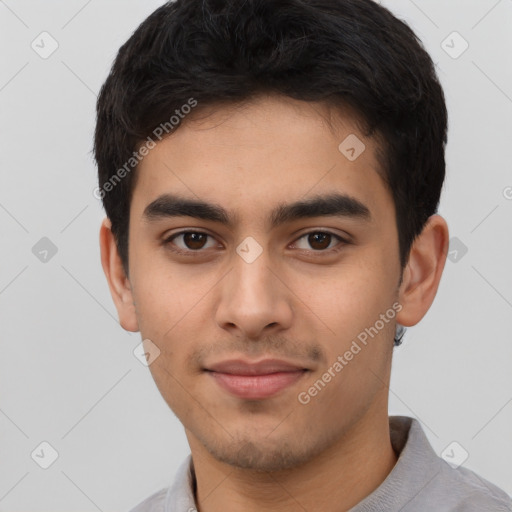 Joyful latino young-adult male with short  brown hair and brown eyes