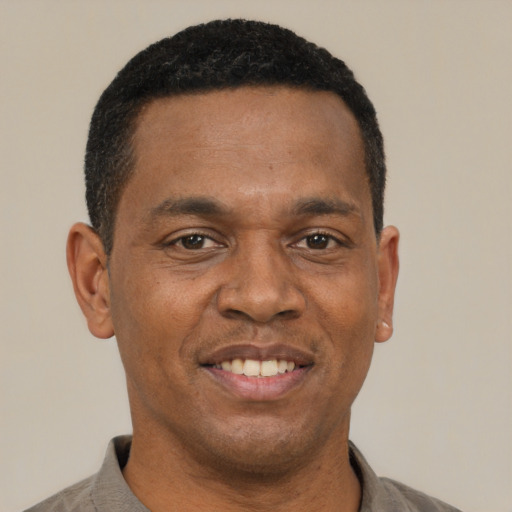 Joyful latino adult male with short  black hair and brown eyes