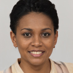 Joyful black young-adult female with short  brown hair and brown eyes