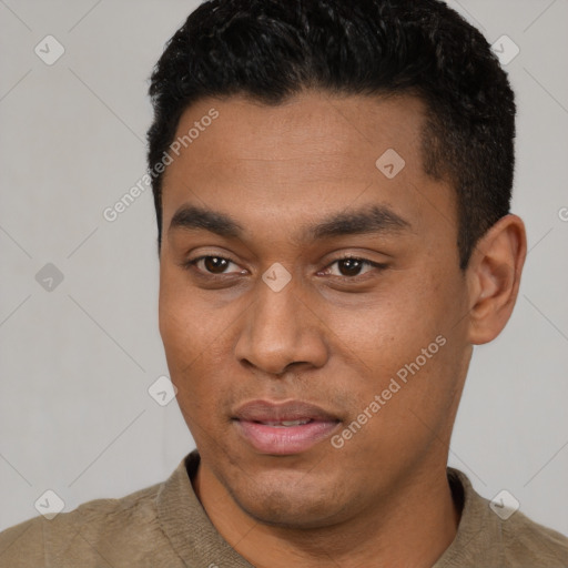 Joyful latino young-adult male with short  black hair and brown eyes