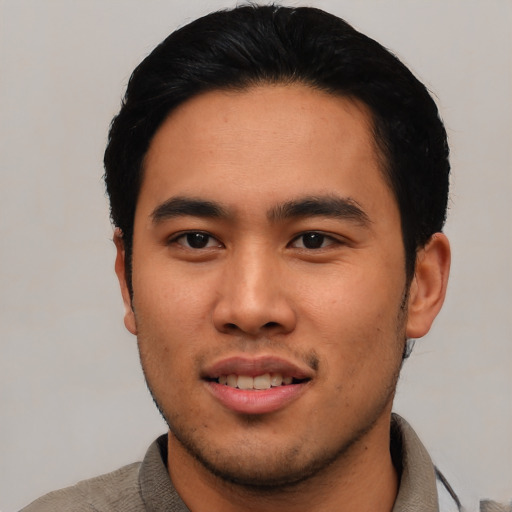 Joyful asian young-adult male with short  black hair and brown eyes