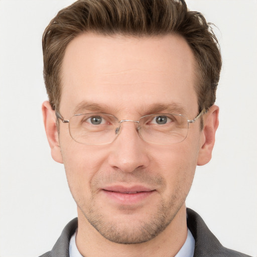 Joyful white adult male with short  brown hair and grey eyes