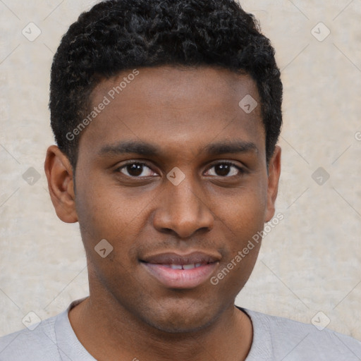 Joyful black young-adult male with short  brown hair and brown eyes