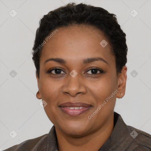 Joyful black adult female with short  black hair and brown eyes