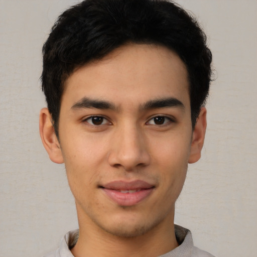 Joyful asian young-adult male with short  brown hair and brown eyes