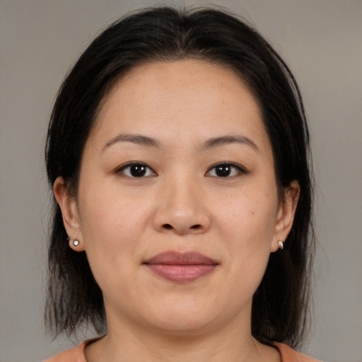 Joyful asian young-adult female with medium  brown hair and brown eyes