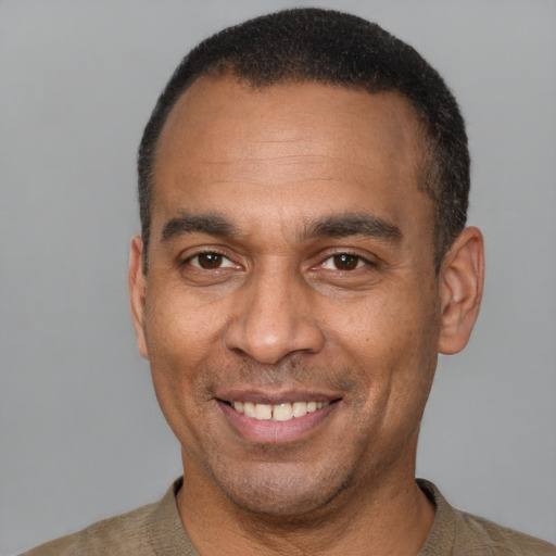 Joyful latino adult male with short  black hair and brown eyes