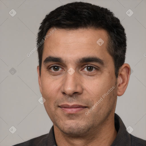 Joyful white young-adult male with short  black hair and brown eyes