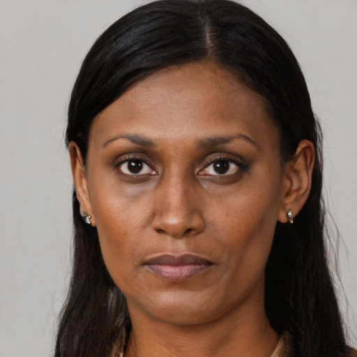 Neutral black adult female with long  brown hair and brown eyes