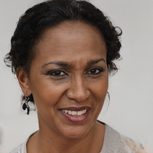 Joyful black adult female with short  brown hair and brown eyes