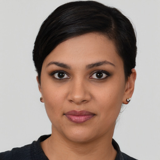 Joyful latino young-adult female with short  black hair and brown eyes
