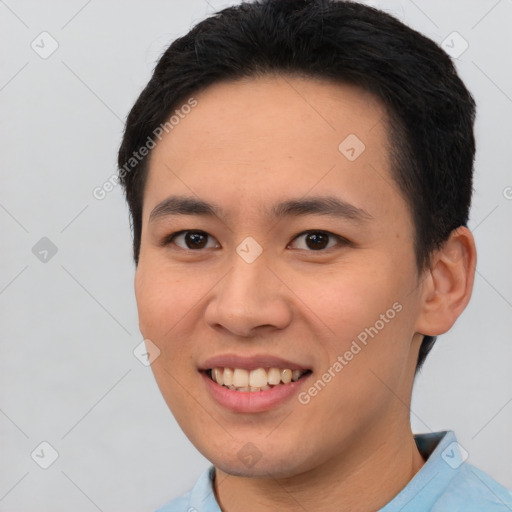 Joyful asian young-adult male with short  black hair and brown eyes