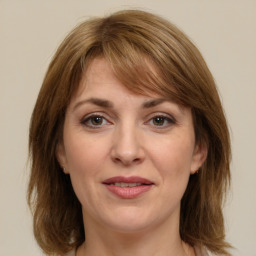 Joyful white adult female with medium  brown hair and grey eyes