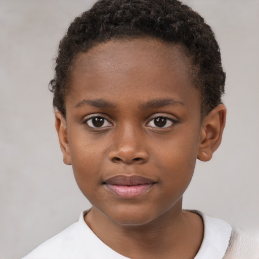Joyful black child male with short  brown hair and brown eyes