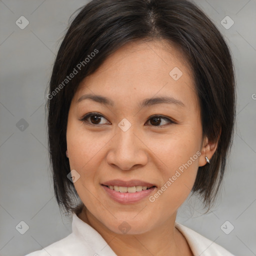 Joyful asian adult female with medium  brown hair and brown eyes