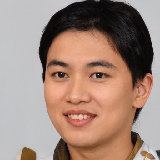 Joyful asian young-adult male with short  brown hair and brown eyes