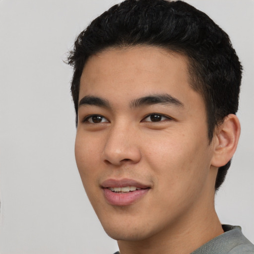 Joyful asian young-adult male with short  black hair and brown eyes