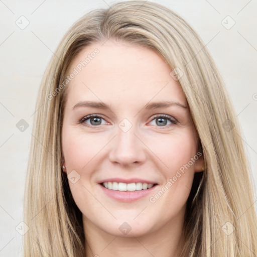 Joyful white young-adult female with long  brown hair and blue eyes