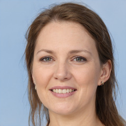 Joyful white adult female with long  brown hair and grey eyes