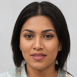 Joyful asian young-adult female with medium  brown hair and brown eyes