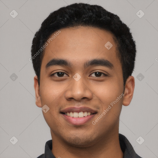 Joyful latino young-adult male with short  black hair and brown eyes