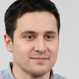 Joyful white adult male with short  brown hair and brown eyes