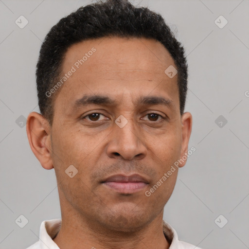 Neutral latino adult male with short  brown hair and brown eyes